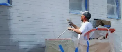 Professional painting a home exterior